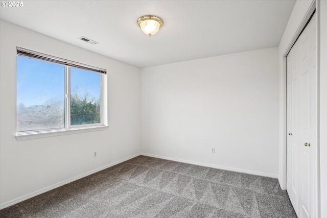 unfurnished bedroom featuring a closet and carpet flooring