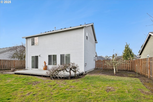 rear view of house featuring a yard and a deck