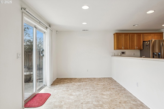 kitchen featuring stainless steel fridge with ice dispenser