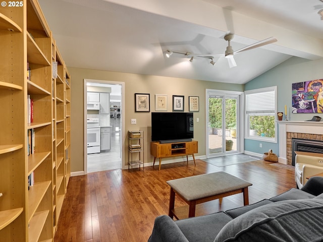 2235 Juntura Ct S, Salem, OR 97302 - living area featuring ceiling fan, a brick fireplace, hardwood / wood-style floors, baseboards, and lofted ceiling