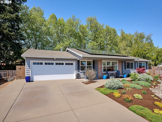 2235 Juntura Ct S, Salem, OR 97302 - ranch-style house with a garage, fence, driveway, and solar panels