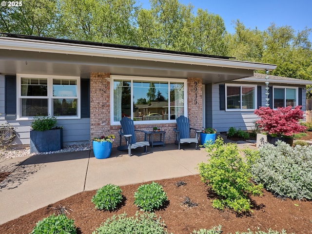 2235 Juntura Ct S, Salem, OR 97302 - rear view of house with a porch and brick siding