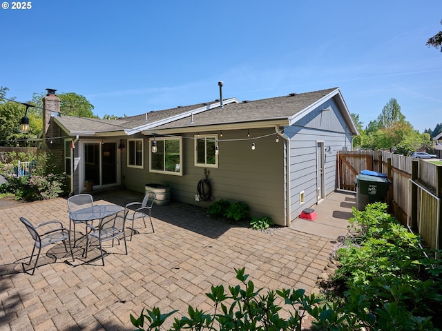 2235 Juntura Ct S, Salem, OR 97302 - rear view of house with a patio, fence, and a chimney