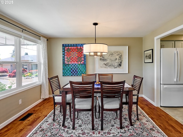 2235 Juntura Ct S, Salem, OR 97302 - dining space with a chandelier, baseboards, visible vents, and wood finished floors