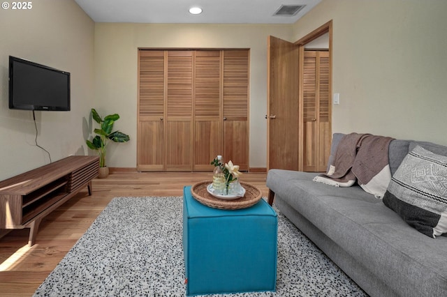 1040 NW Naito Pkwy Unit O-10, Portland, OR 97209 - living room with wood finished floors and recessed lighting