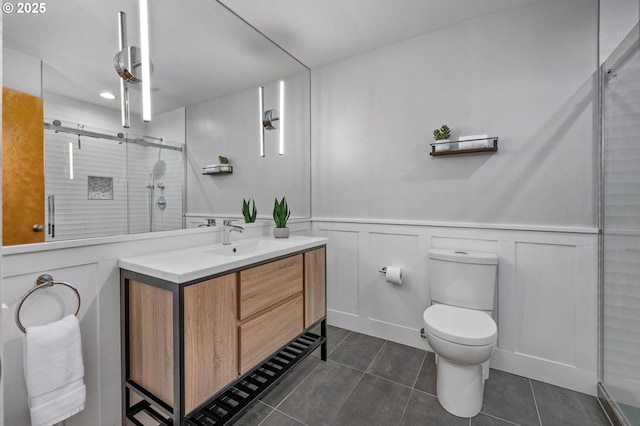 1040 NW Naito Pkwy Unit O-10, Portland, OR 97209 - bathroom with vanity, tile patterned floors, a stall shower, a decorative wall, and wainscoting