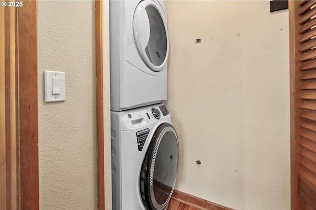 1040 NW Naito Pkwy Unit O-10, Portland, OR 97209 - laundry room with estacked washer and dryer and wood finished floors