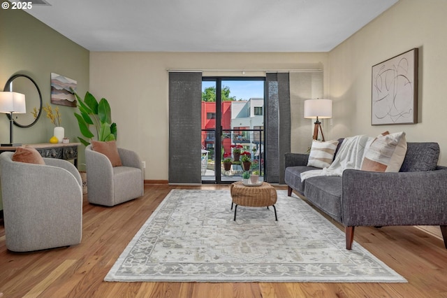 1040 NW Naito Pkwy Unit O-10, Portland, OR 97209 - living room featuring wood finished floors and baseboards