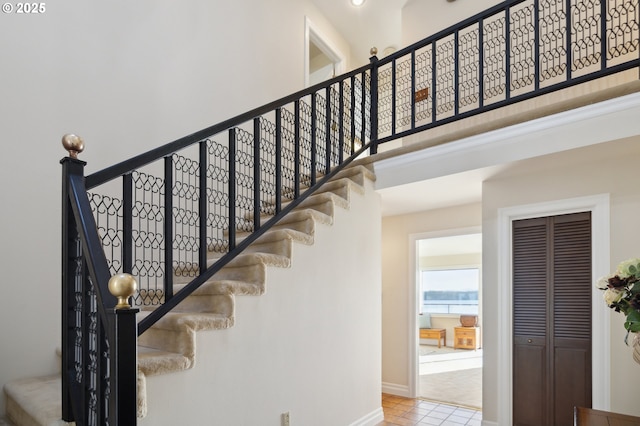 stairs featuring tile patterned flooring