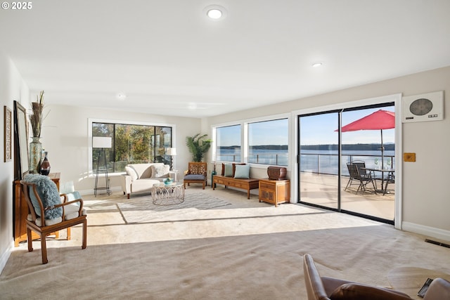 carpeted living room with a water view