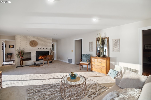 living room with carpet flooring and a brick fireplace