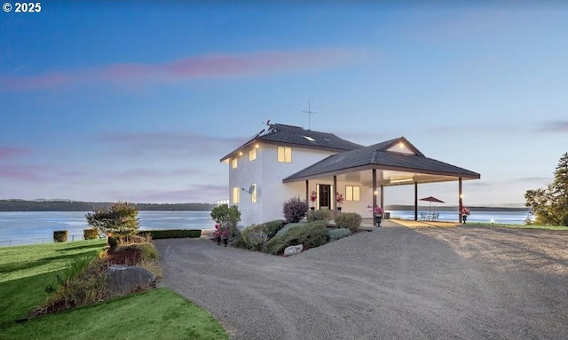 country-style home featuring a water view and a carport