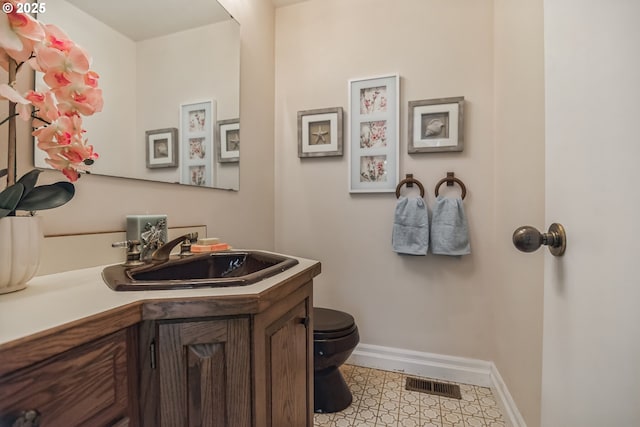 bathroom with vanity and toilet