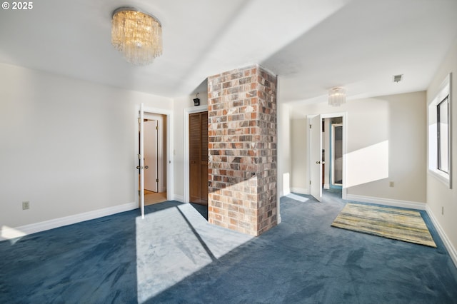 empty room featuring dark colored carpet and lofted ceiling