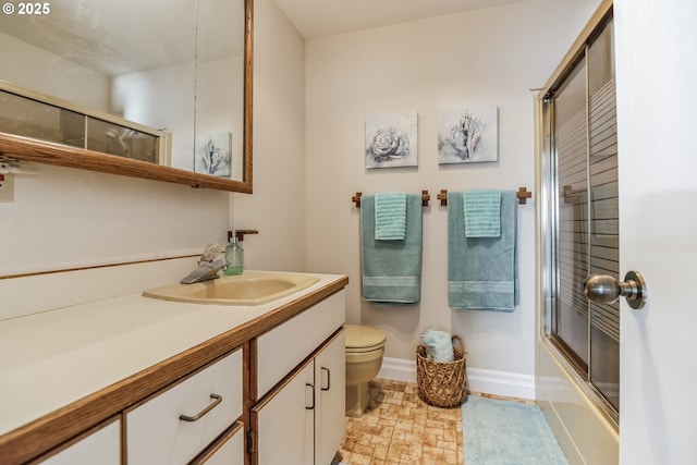 full bathroom with vanity, enclosed tub / shower combo, and toilet