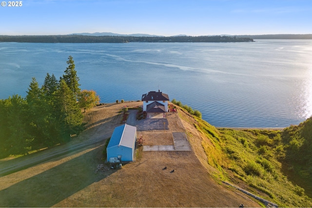 drone / aerial view with a water and mountain view