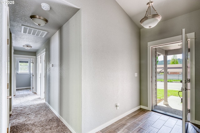 1545 E Fourth Ave, Sutherlin, OR 97479 - entryway with baseboards, a textured ceiling, and a textured wall