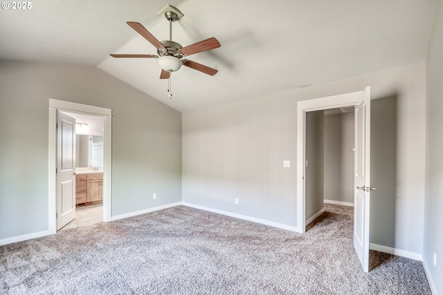 1545 E Fourth Ave, Sutherlin, OR 97479 - unfurnished bedroom featuring carpet flooring, vaulted ceiling, baseboards, a ceiling fan, and ensuite bathroom