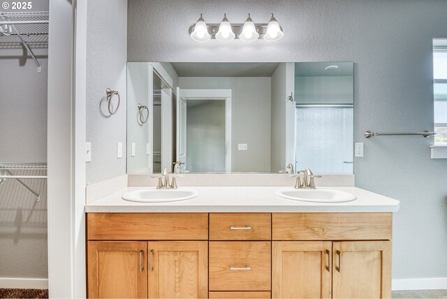 1545 E Fourth Ave, Sutherlin, OR 97479 - bathroom with a spacious closet, double vanity, a textured wall, and an enclosed shower