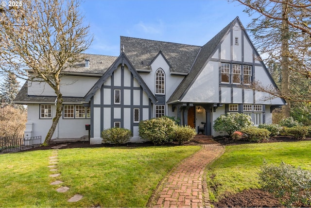 english style home featuring a front lawn