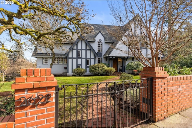 tudor home featuring a front lawn