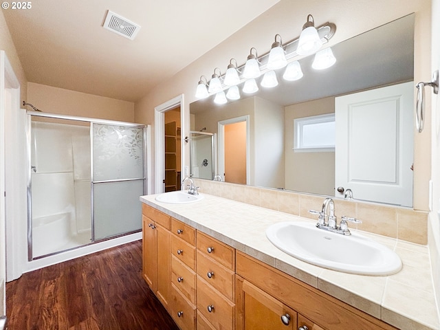 bathroom featuring vanity, hardwood / wood-style floors, and walk in shower