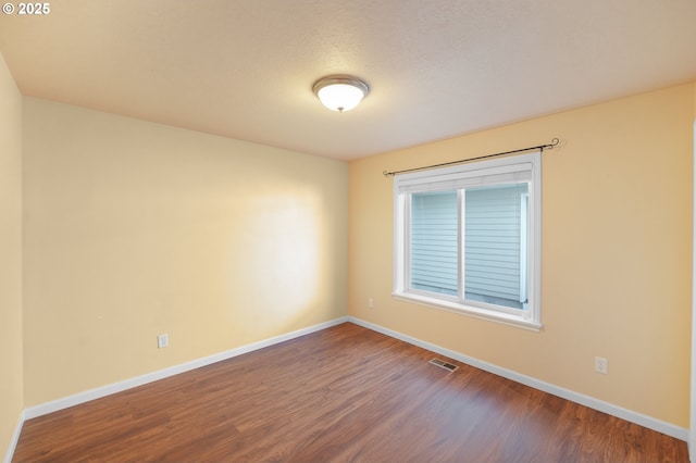 spare room with hardwood / wood-style flooring