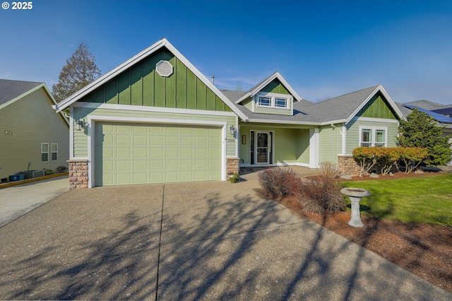 craftsman inspired home featuring a garage and central air condition unit