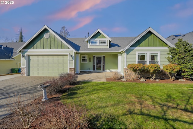 craftsman-style home featuring a garage and a yard