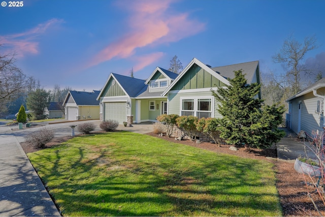 craftsman inspired home featuring a yard and a garage