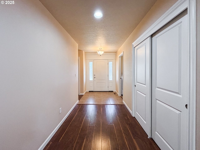 entryway featuring hardwood / wood-style floors and a textured ceiling