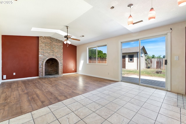 400 S 28th Ave, Cornelius, OR 97113 - unfurnished living room with vaulted ceiling, wood finished floors, ceiling fan, a fireplace, and baseboards