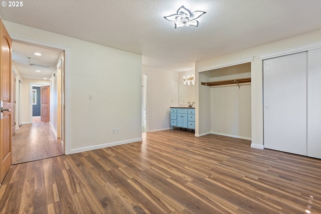 400 S 28th Ave, Cornelius, OR 97113 - unfurnished bedroom featuring multiple closets, dark wood finished floors, a chandelier, baseboards, and a textured ceiling