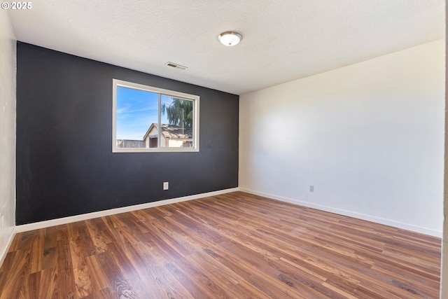 400 S 28th Ave, Cornelius, OR 97113 - unfurnished room featuring wood finished floors, baseboards, and a textured ceiling