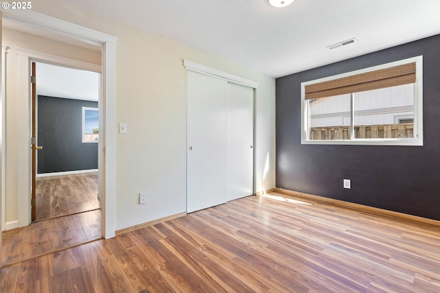 400 S 28th Ave, Cornelius, OR 97113 - unfurnished bedroom with wood finished floors, a closet, and baseboards