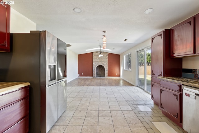 400 S 28th Ave, Cornelius, OR 97113 - kitchen with appliances with stainless steel finishes, lofted ceiling, a fireplace, dark brown cabinets, and open floor plan