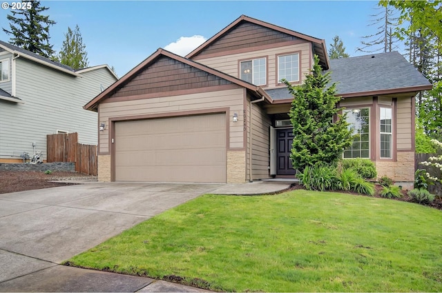 craftsman-style home featuring fence, an attached garage, driveway, and a front lawn