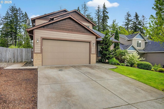 craftsman inspired home featuring brick siding, fence, a front lawn, concrete driveway, and an attached garage