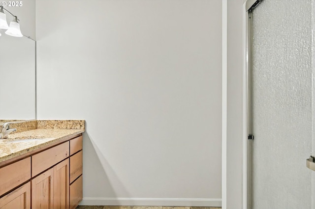 bathroom with vanity and baseboards