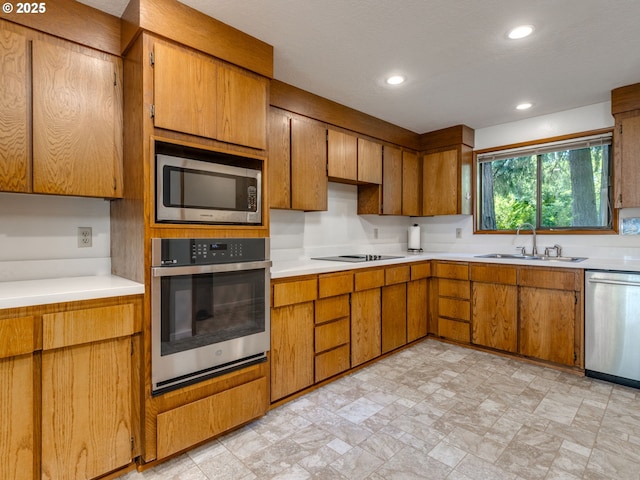 7785 SW W Slope Dr, Portland, OR 97225 - kitchen with appliances with stainless steel finishes, brown cabinets, and recessed lighting