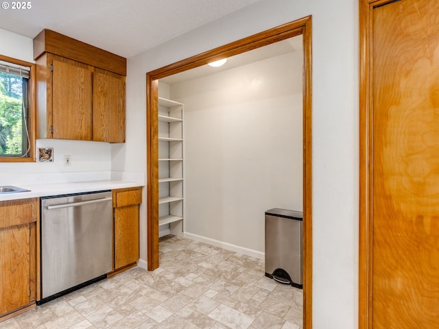 7785 SW W Slope Dr, Portland, OR 97225 - kitchen featuring dishwasher, brown cabinetry, and light countertops