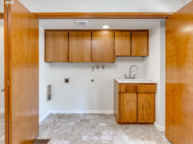 7785 SW W Slope Dr, Portland, OR 97225 - washroom with cabinet space, electric dryer hookup, washer hookup, gas dryer hookup, and light stone finish flooring