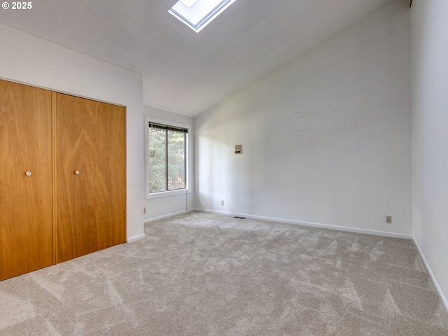 7785 SW W Slope Dr, Portland, OR 97225 - unfurnished bedroom featuring lofted ceiling, carpet flooring, a skylight, and a closet