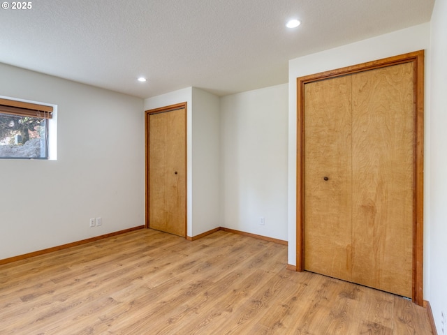 7785 SW W Slope Dr, Portland, OR 97225 - unfurnished bedroom with light wood-type flooring, recessed lighting, and a textured ceiling
