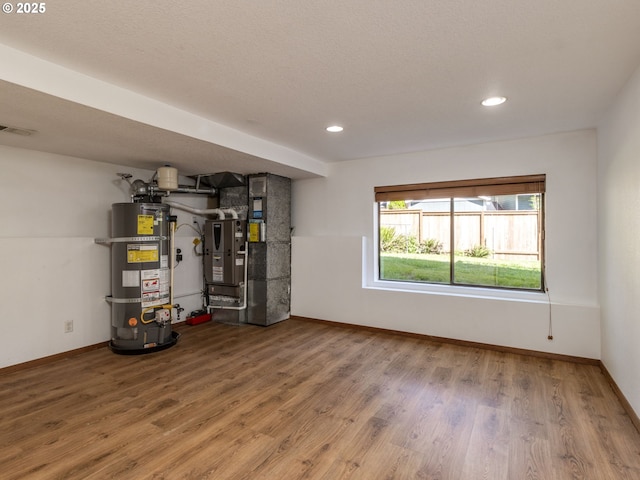 7785 SW W Slope Dr, Portland, OR 97225 - utility room featuring strapped water heater and heating unit
