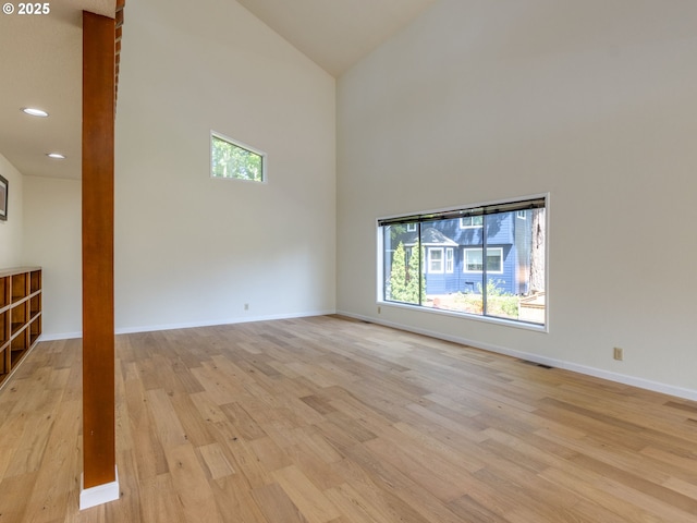 7785 SW W Slope Dr, Portland, OR 97225 - empty room with high vaulted ceiling, plenty of natural light, light wood-style flooring, and recessed lighting