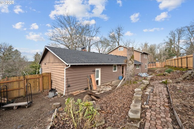 7080 SW Taylors Ferry Rd, Portland, OR 97223 - view of side of property featuring a shingled roof and a chimney