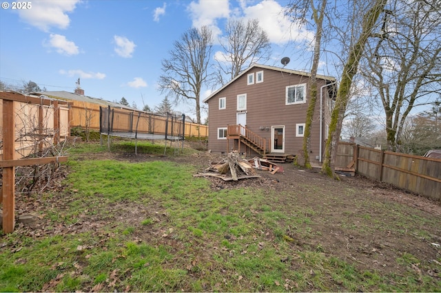 7080 SW Taylors Ferry Rd, Portland, OR 97223 - back of house with a trampoline and a fenced backyard
