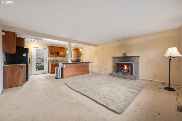 7080 SW Taylors Ferry Rd, Portland, OR 97223 - unfurnished living room featuring a brick fireplace and unfinished concrete floors