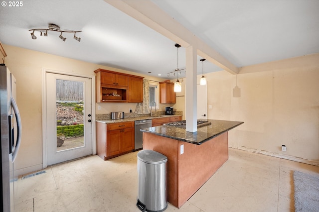 7080 SW Taylors Ferry Rd, Portland, OR 97223 - kitchen with stainless steel appliances, a sink, dark stone counters, and brown cabinets
